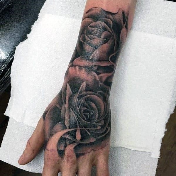 Mens flower hand tattoos