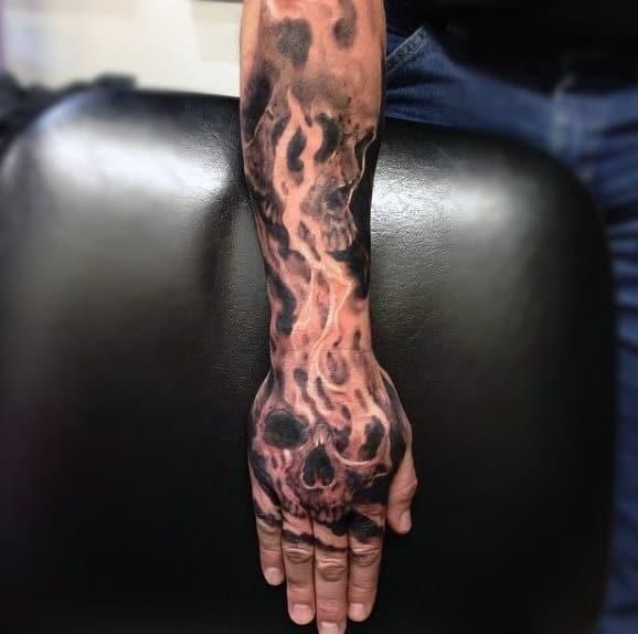 Mens hand tattoo of skull on fire
