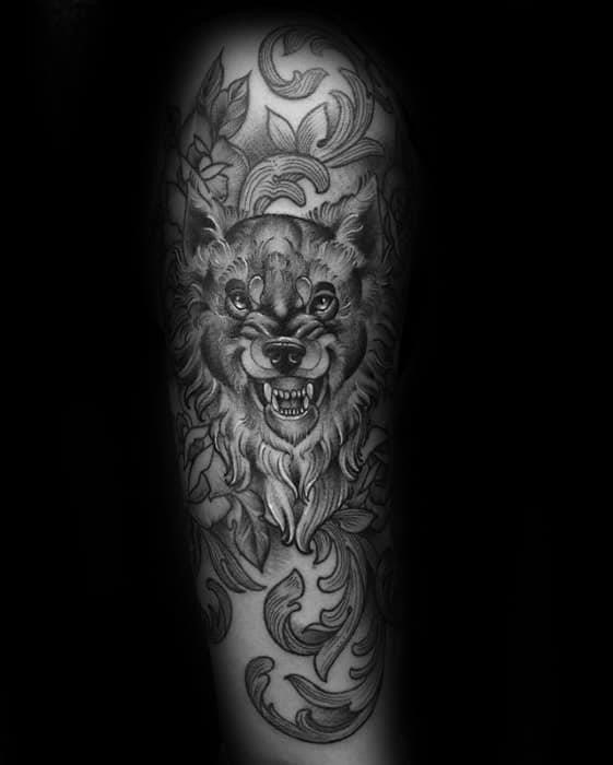 Ornate arm male tattoo with sick wolf design