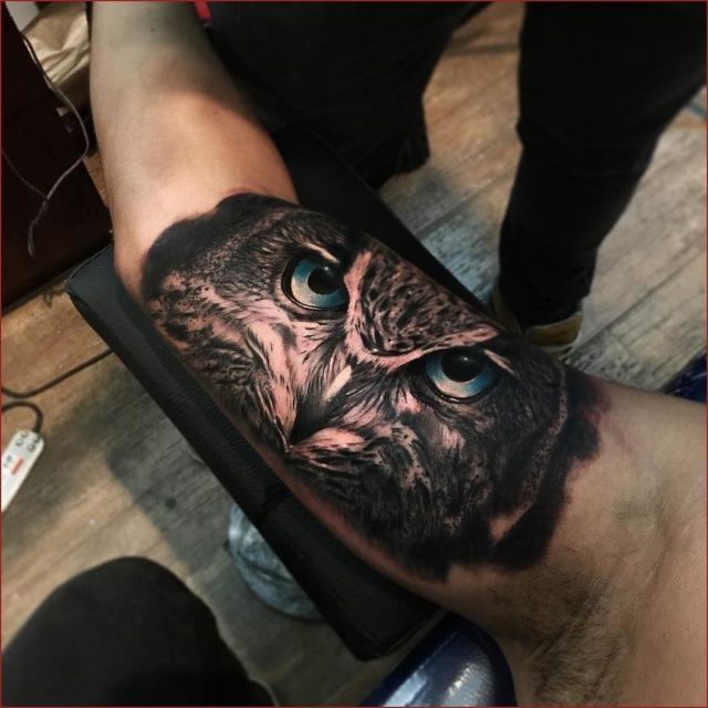 Owl face inner bicep tattoo for men