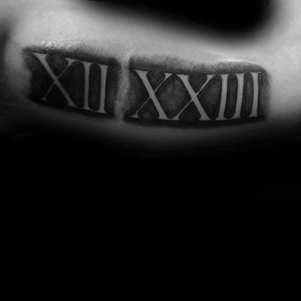 Shaded roman numeral negative space guys arm tattoos