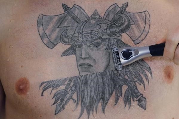 Shaved viking tattoo on chest for men