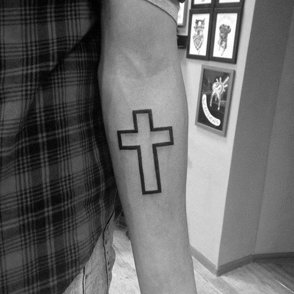 Simple cross with black ink outline shape mens inner forearm tattoo