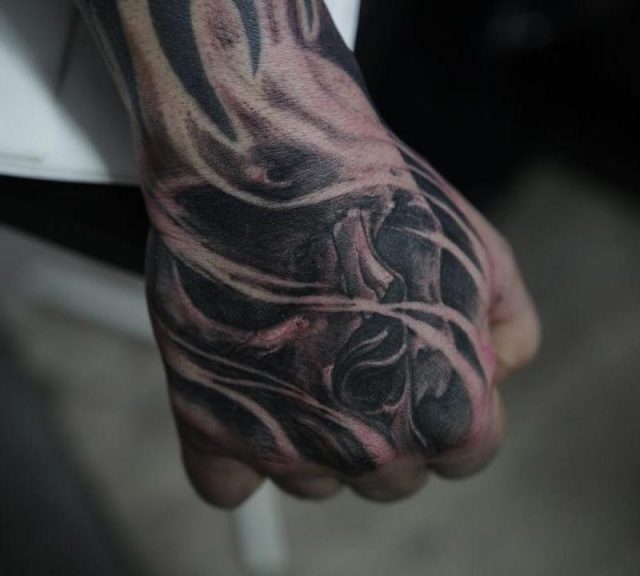 Skull hand tattoo