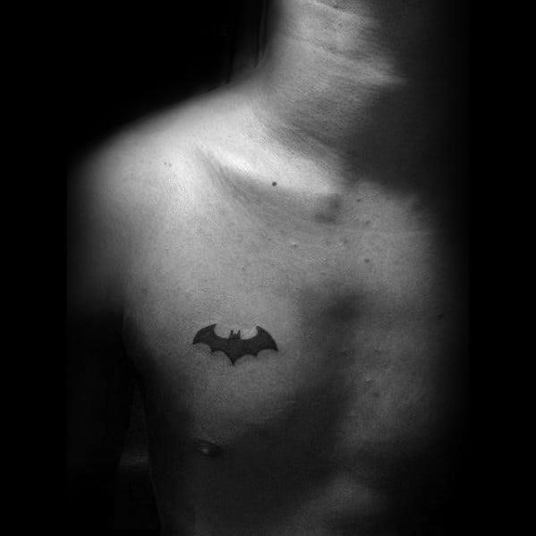 Small batman solid black ink guys chest tattoo designs