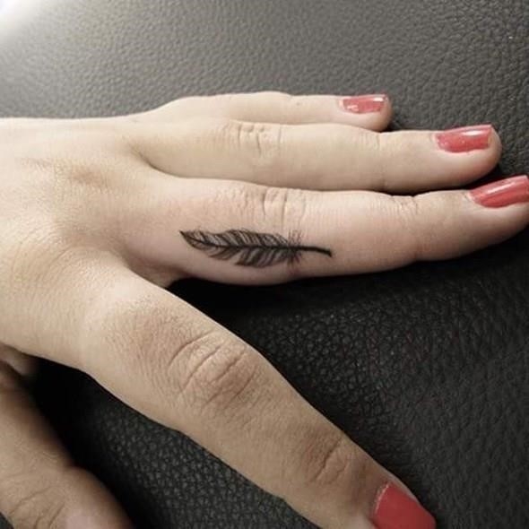 Small feather tattoo finger