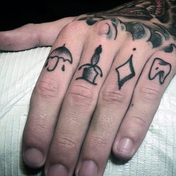 Small knuckle tattoo symbols on man