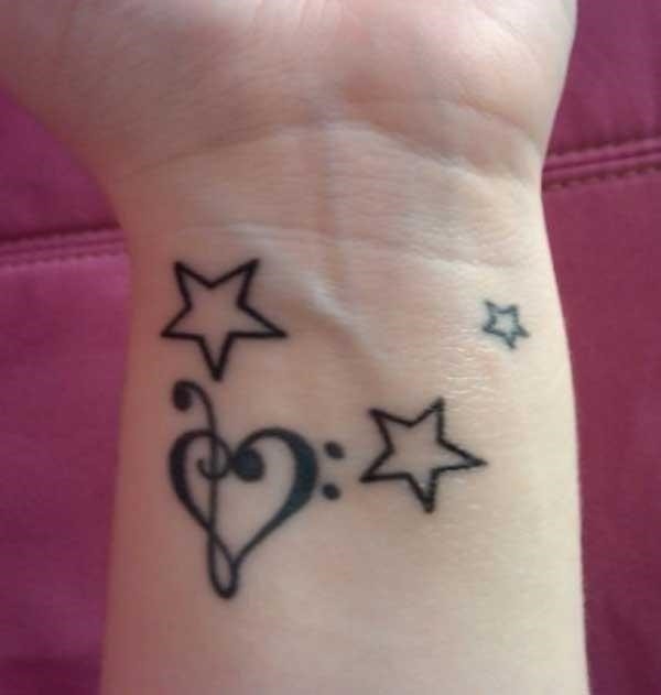 Stars and heart feminine tattoo on wrist