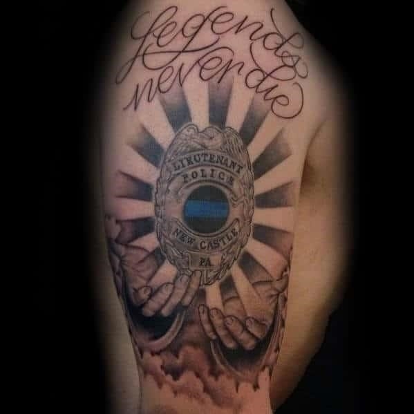 Sun rays with hands holding police badge mens arm tattoos