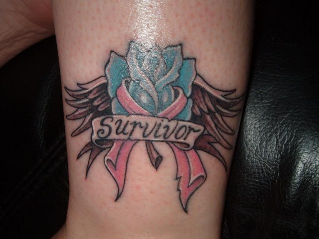 Survivor banner with cancer tattoo on bicep