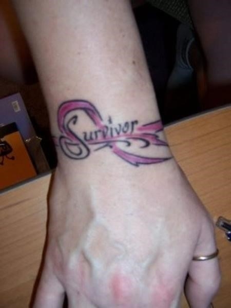 Survivor pink ribbon cancer tattoo on wrist
