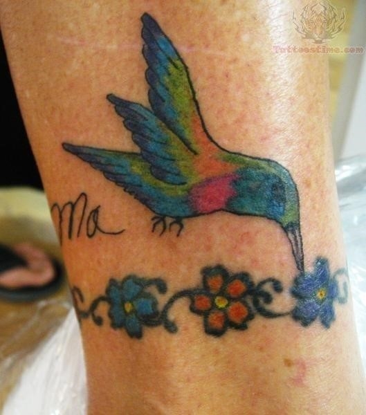Tiny flowers and hummingbird tattoo