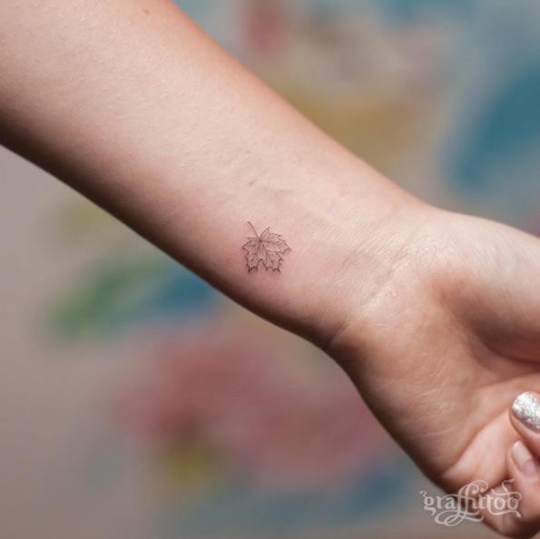 Tiny maple leaf tattoo