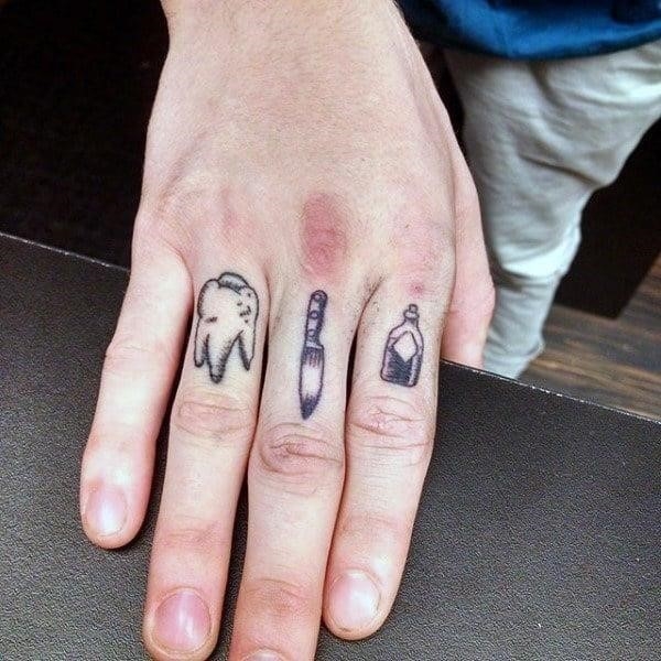 Tooth knife and bottle male tattoos on fingers