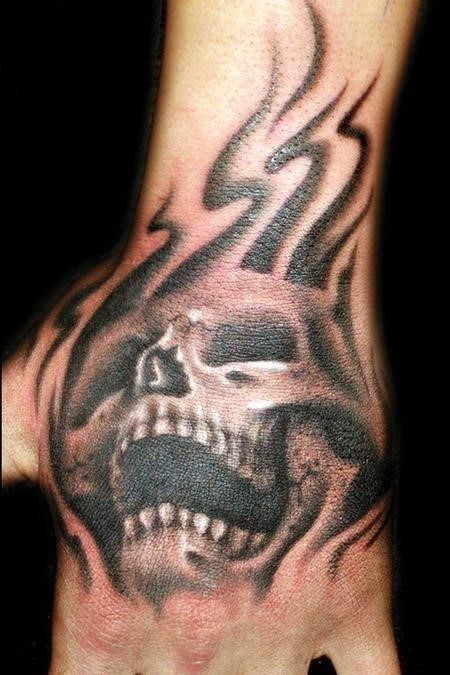 Tribal and skull hand tattoo