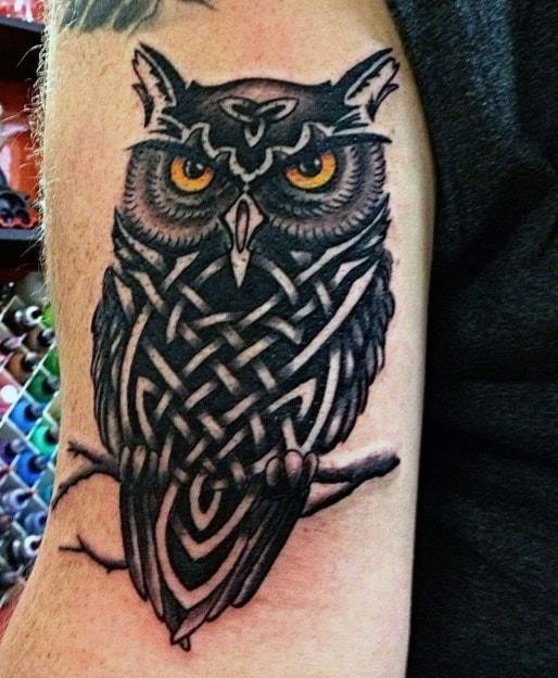 Tribal owl head guys tattoo