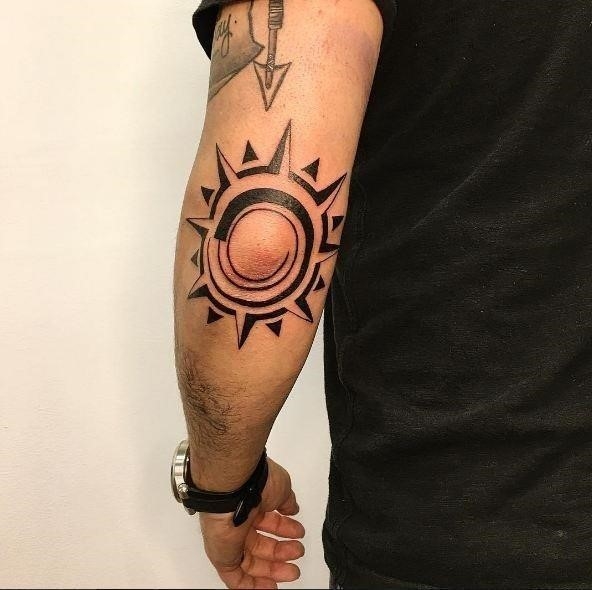 Tribal sun elbow tattoos