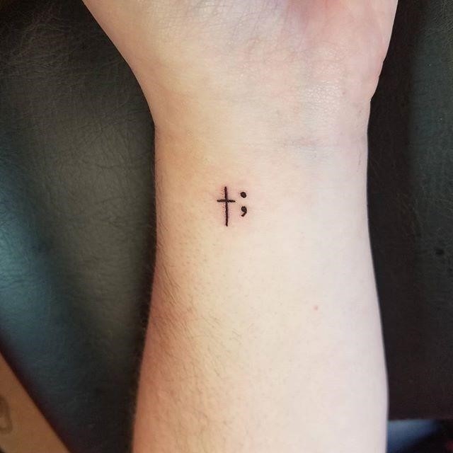 Women tattoo cross and semi colon tattoo done by cam whaley at walls of wonder tattoo in dove